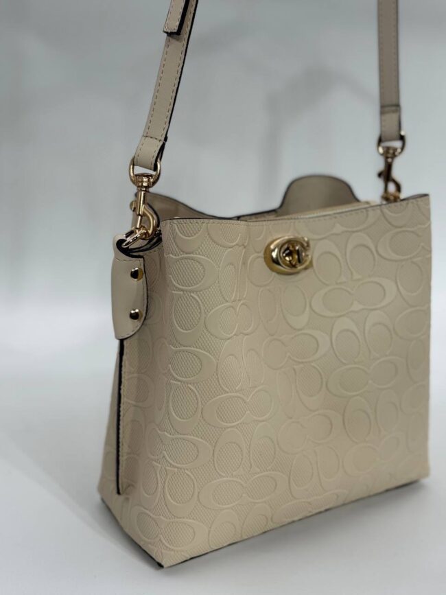 Coach Gofraj baskılı kilitli büzgülü bej çanta